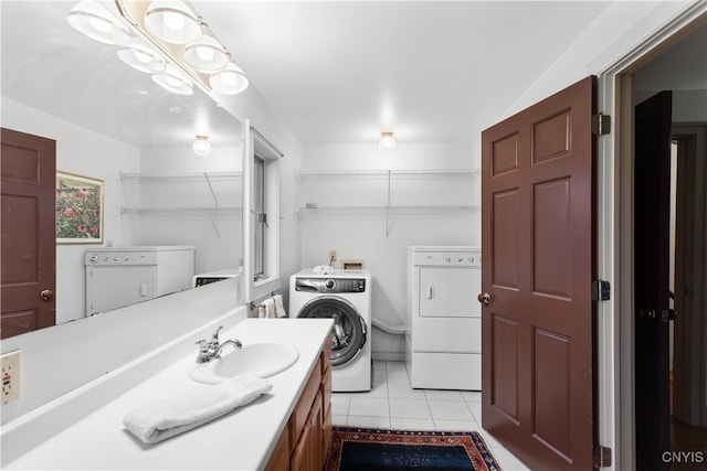 bathroom featuring washer and clothes dryer, sink, and tile patterned floors