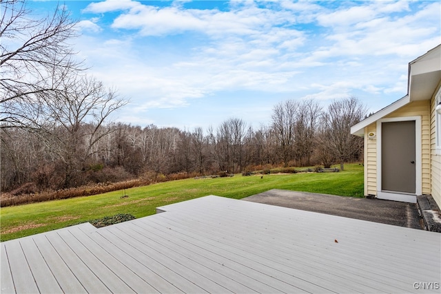 wooden terrace with a lawn