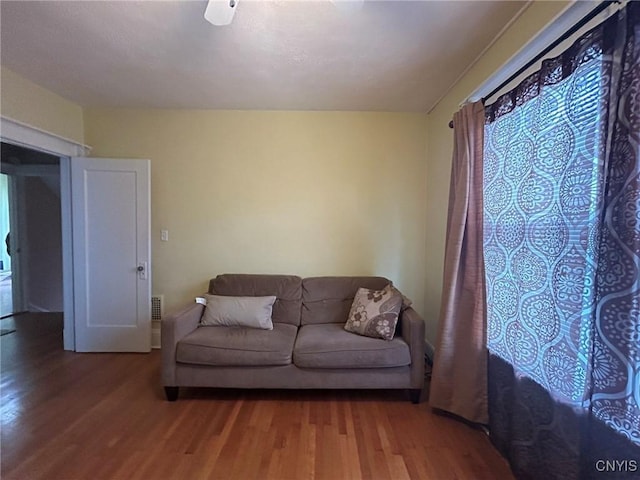 living room with hardwood / wood-style floors and ceiling fan