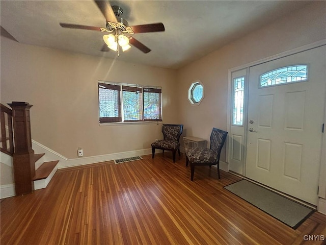 foyer entrance with ceiling fan and wood-type flooring