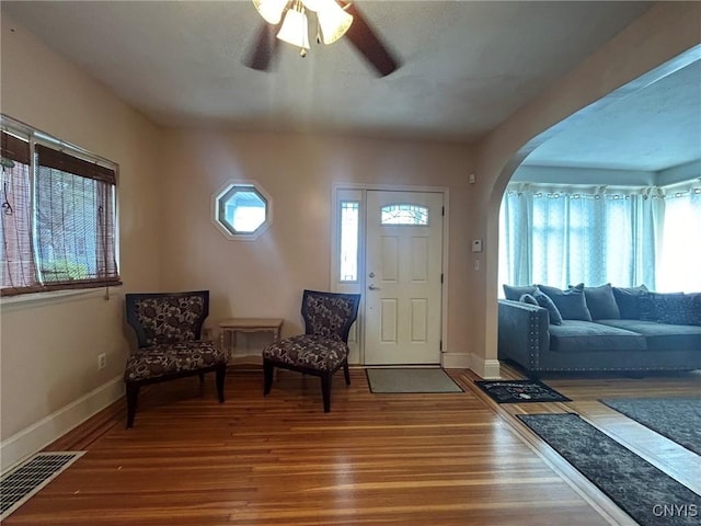 foyer entrance with hardwood / wood-style flooring and ceiling fan