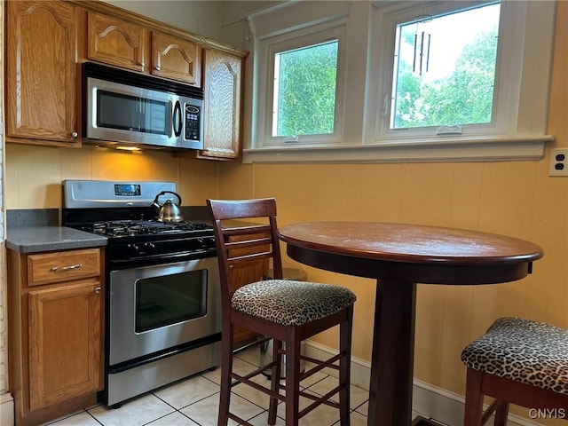 kitchen featuring light tile patterned floors and stainless steel appliances