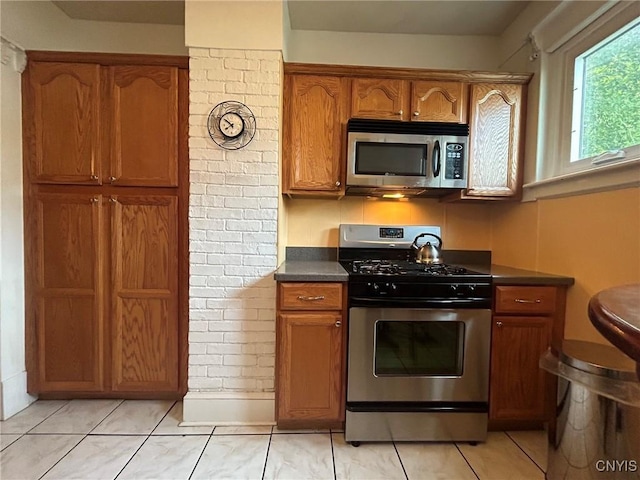 kitchen with light tile patterned floors and appliances with stainless steel finishes