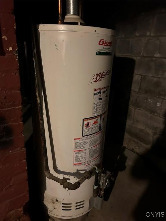 utility room featuring water heater