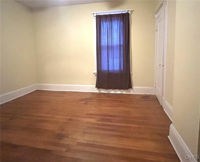 spare room with dark hardwood / wood-style flooring