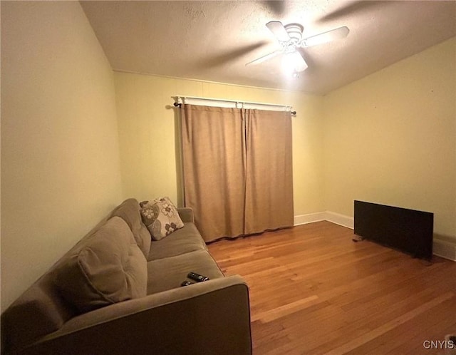 living room featuring ceiling fan and wood-type flooring