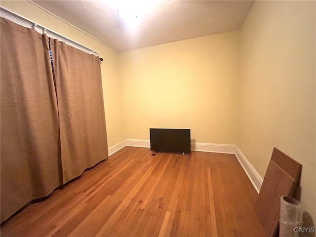 unfurnished room with hardwood / wood-style floors