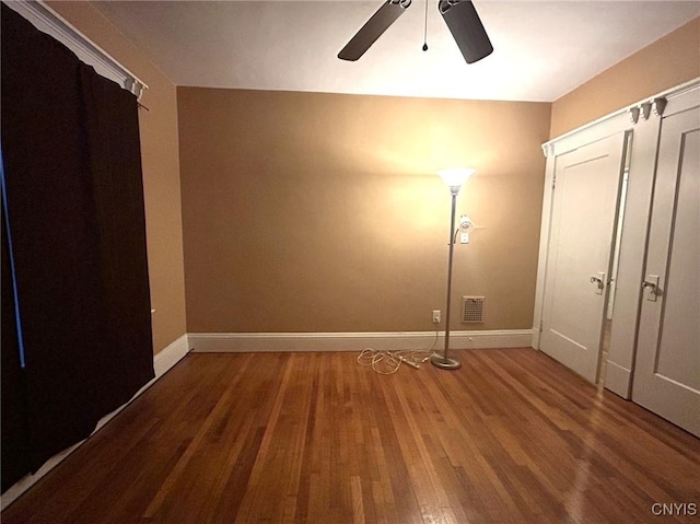 unfurnished bedroom featuring hardwood / wood-style floors and ceiling fan