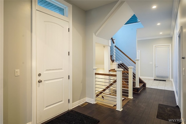 entryway with crown molding and wood-type flooring