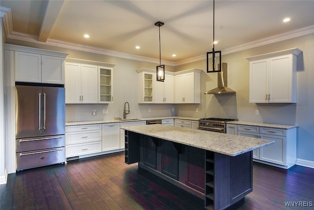 kitchen with wall chimney exhaust hood, high end appliances, dark hardwood / wood-style floors, a kitchen island, and hanging light fixtures