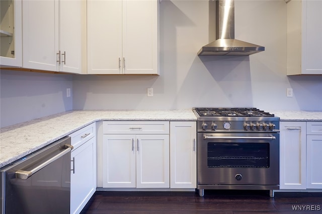 kitchen featuring white cabinets, appliances with stainless steel finishes, dark hardwood / wood-style flooring, and wall chimney exhaust hood