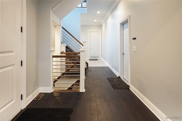 hallway featuring wood-type flooring and ornamental molding