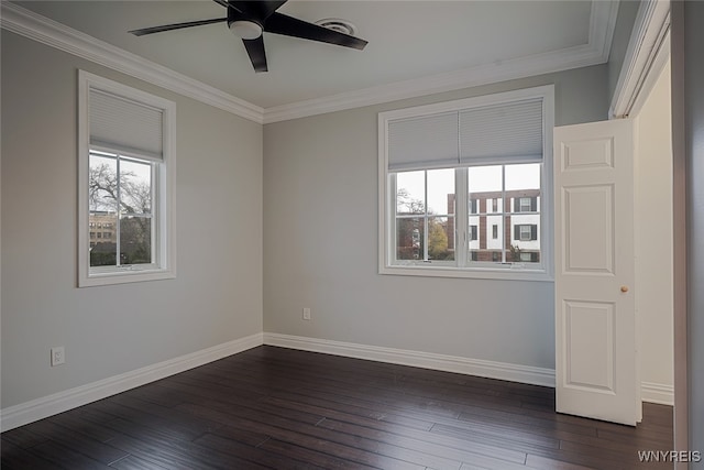 empty room with ceiling fan, plenty of natural light, and dark hardwood / wood-style floors