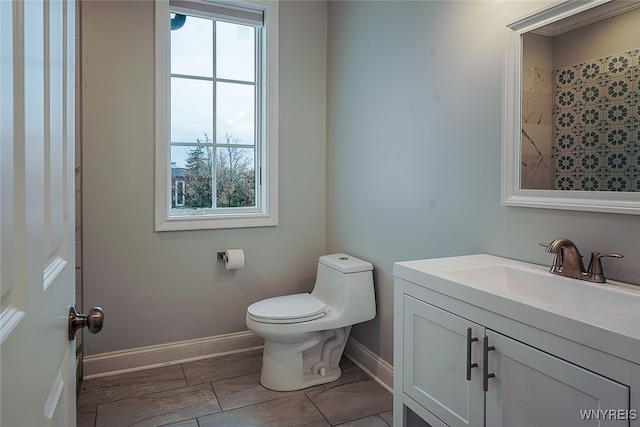 bathroom featuring vanity, toilet, and a wealth of natural light