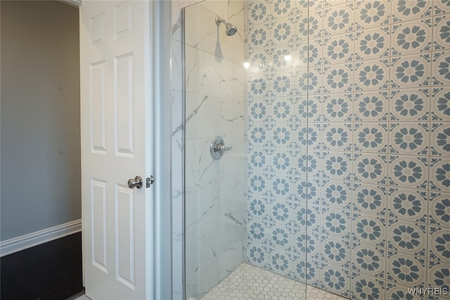 bathroom with tiled shower