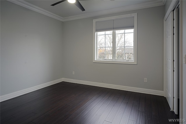 unfurnished bedroom featuring ceiling fan, dark hardwood / wood-style flooring, crown molding, and a closet