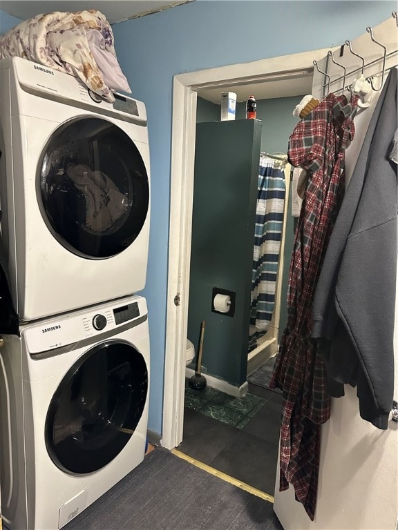 laundry room with stacked washer / drying machine