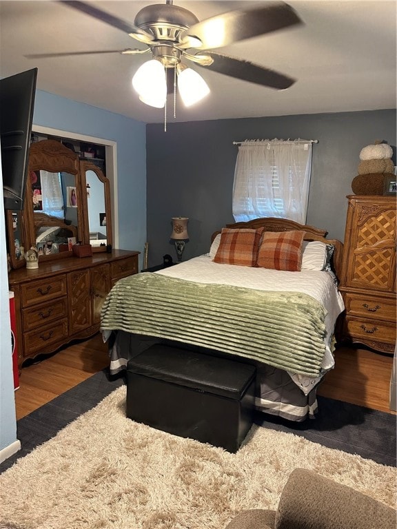 bedroom with ceiling fan and dark hardwood / wood-style floors