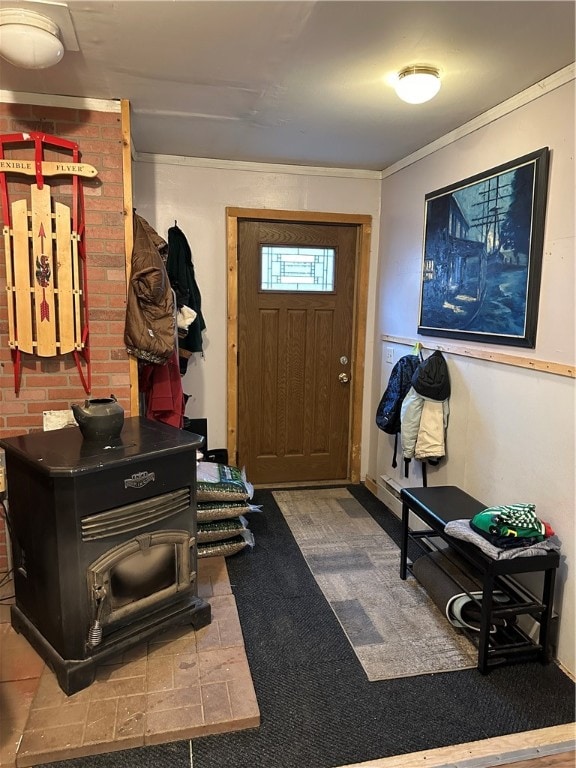 entrance foyer featuring crown molding and a wood stove