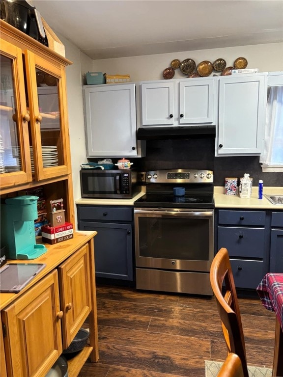 kitchen featuring white cabinets, dark hardwood / wood-style floors, stainless steel electric range oven, and backsplash