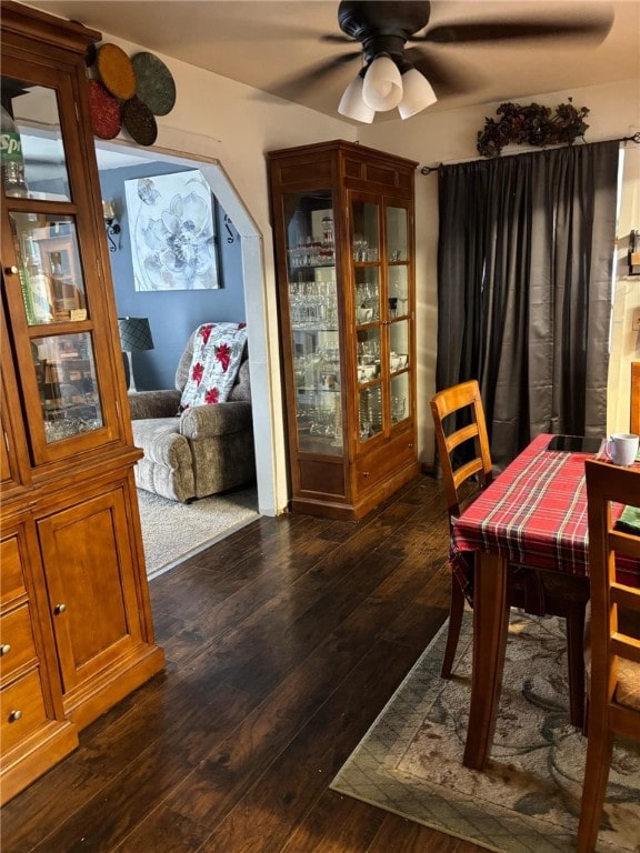 dining area with ceiling fan and dark hardwood / wood-style flooring