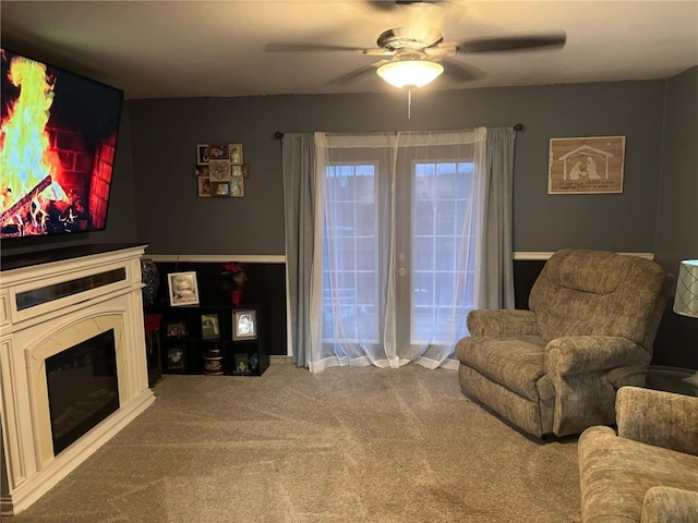 living room featuring ceiling fan and carpet floors