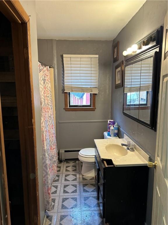 bathroom featuring vanity, a baseboard radiator, and toilet