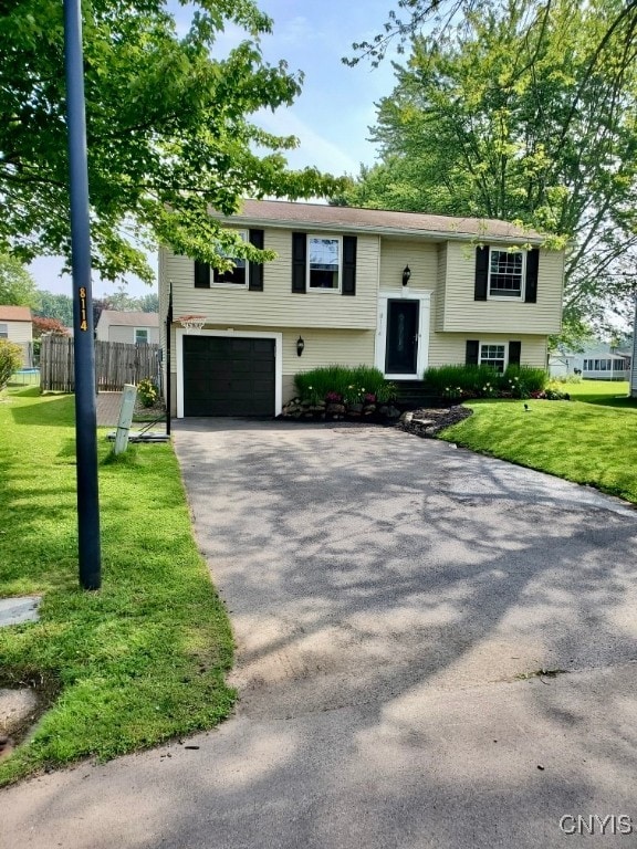 bi-level home with a front yard and a garage