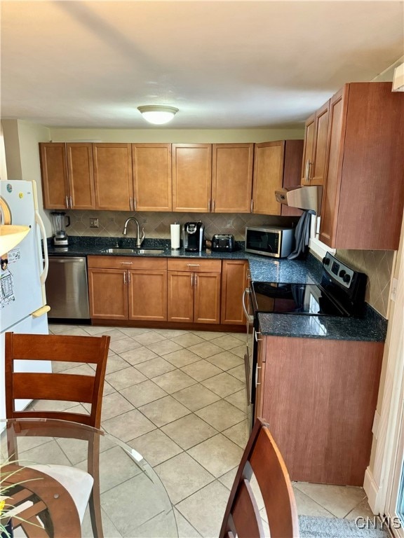 kitchen with backsplash, ventilation hood, sink, light tile patterned floors, and appliances with stainless steel finishes