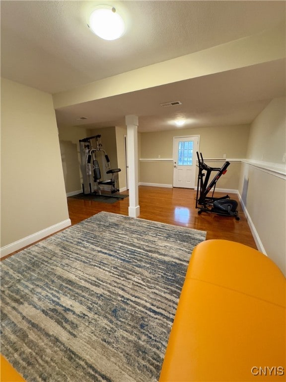 exercise room featuring dark wood-type flooring