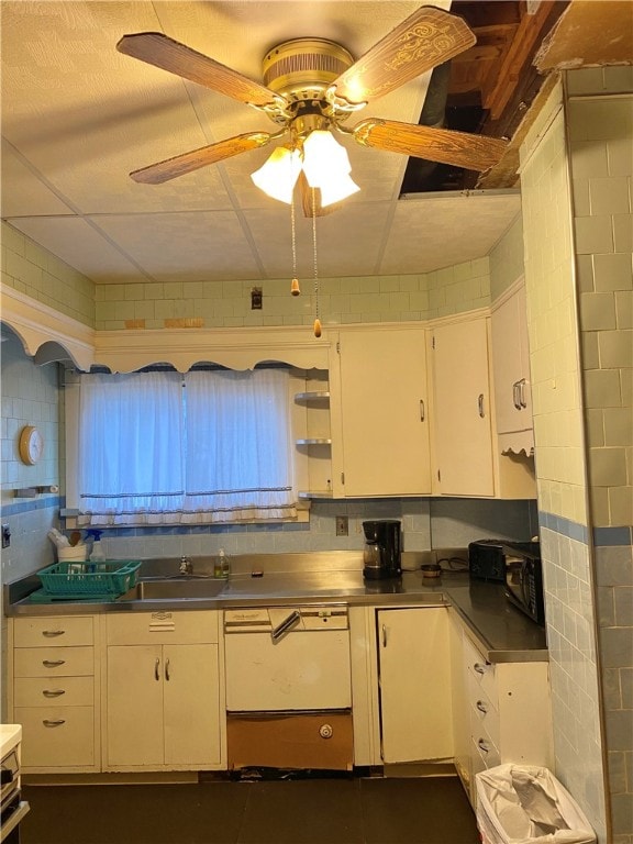 kitchen with white cabinets, stainless steel counters, ceiling fan, and tasteful backsplash