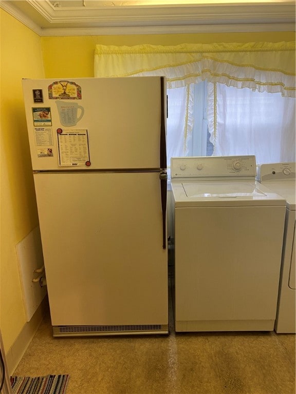 washroom with separate washer and dryer and ornamental molding