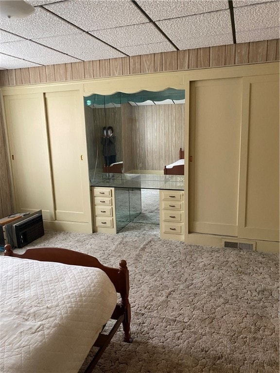 bedroom featuring carpet flooring and a paneled ceiling