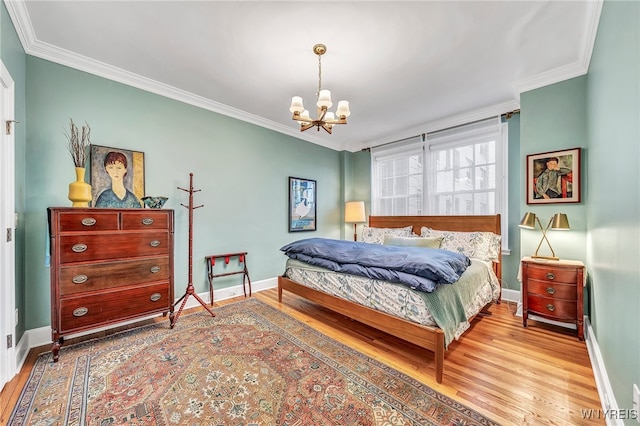 bedroom with wood-type flooring, ornamental molding, and a chandelier