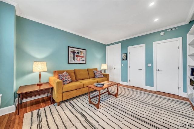 living room with light hardwood / wood-style flooring and ornamental molding