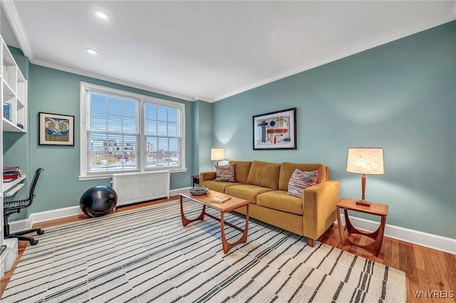 living room featuring light hardwood / wood-style flooring and crown molding