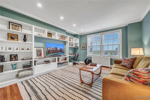 living room featuring hardwood / wood-style floors and crown molding