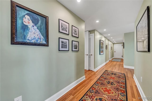 hallway with light hardwood / wood-style floors