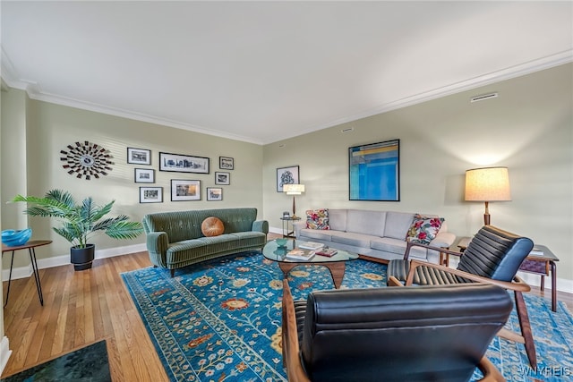 living room with hardwood / wood-style floors and ornamental molding