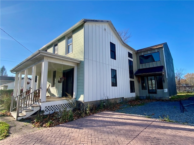 view of side of home with a porch