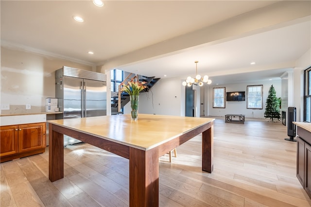 recreation room featuring light wood-type flooring and a notable chandelier