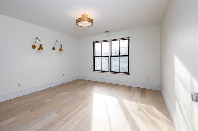 unfurnished room with light wood-type flooring