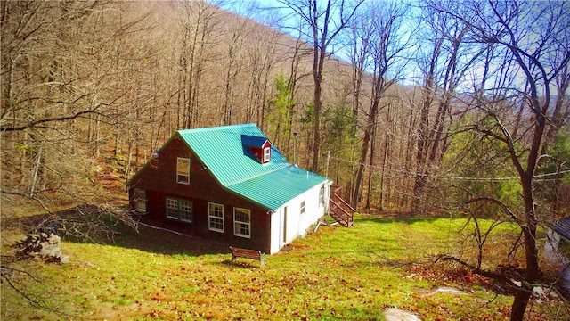 view of side of property with a lawn