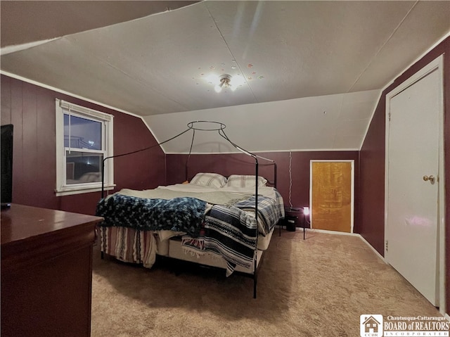 carpeted bedroom with lofted ceiling