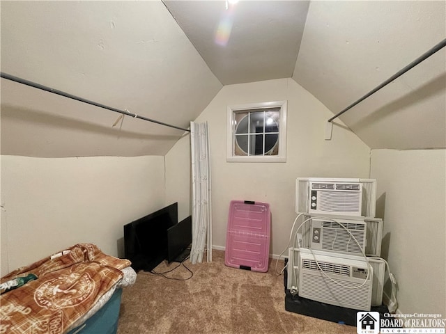 bonus room featuring light carpet, an AC wall unit, and lofted ceiling