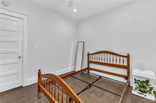 bedroom with dark wood-type flooring