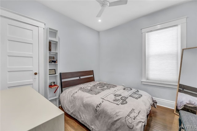 bedroom featuring ceiling fan and dark hardwood / wood-style flooring