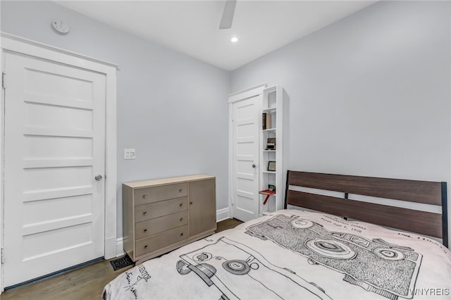 bedroom with ceiling fan and dark hardwood / wood-style floors