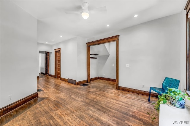 empty room with hardwood / wood-style flooring and ceiling fan