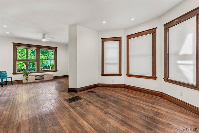 unfurnished living room featuring dark hardwood / wood-style floors and ceiling fan